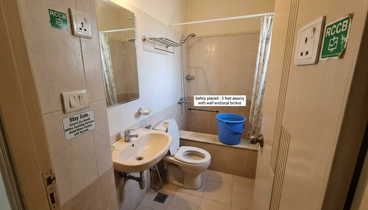 Wide-angle view of a bathroom bucket placed away from a raised safe power socket