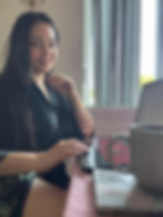 gfe escort wearing a silk robe at her desk with a laptop
