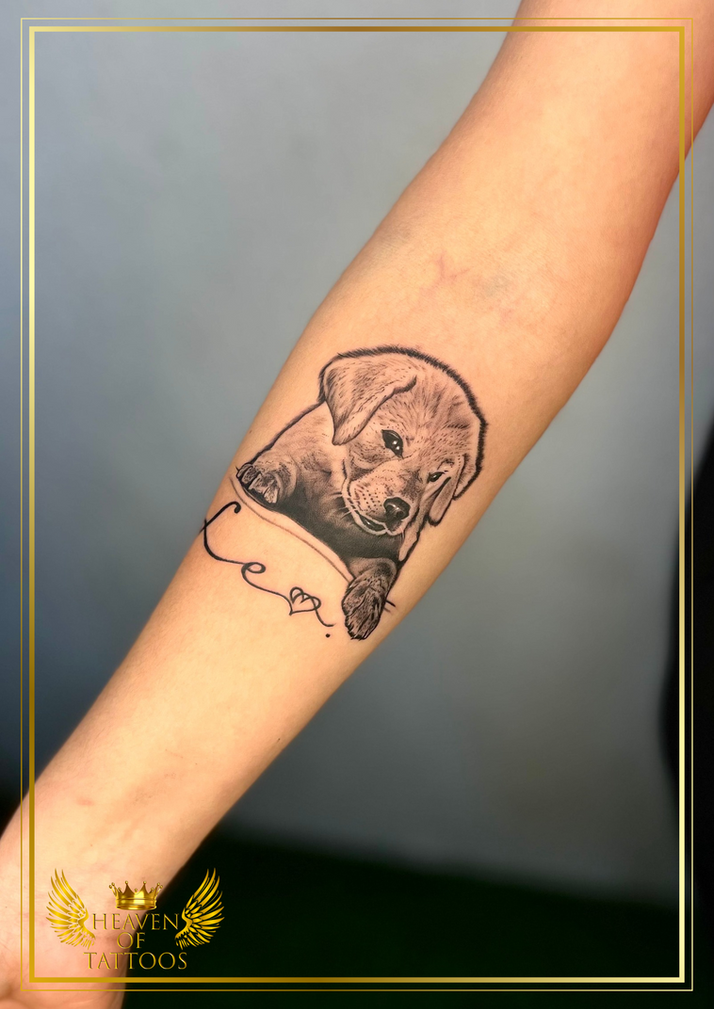 Realistic puppy tattoo on forearm with name script design, done at Heaven of Tattoos