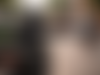 Motorcyclist using hand signals while riding on an Indian road with traffic around