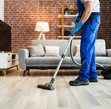man-uniform-vacuuming-house-floor-4286571.jpg