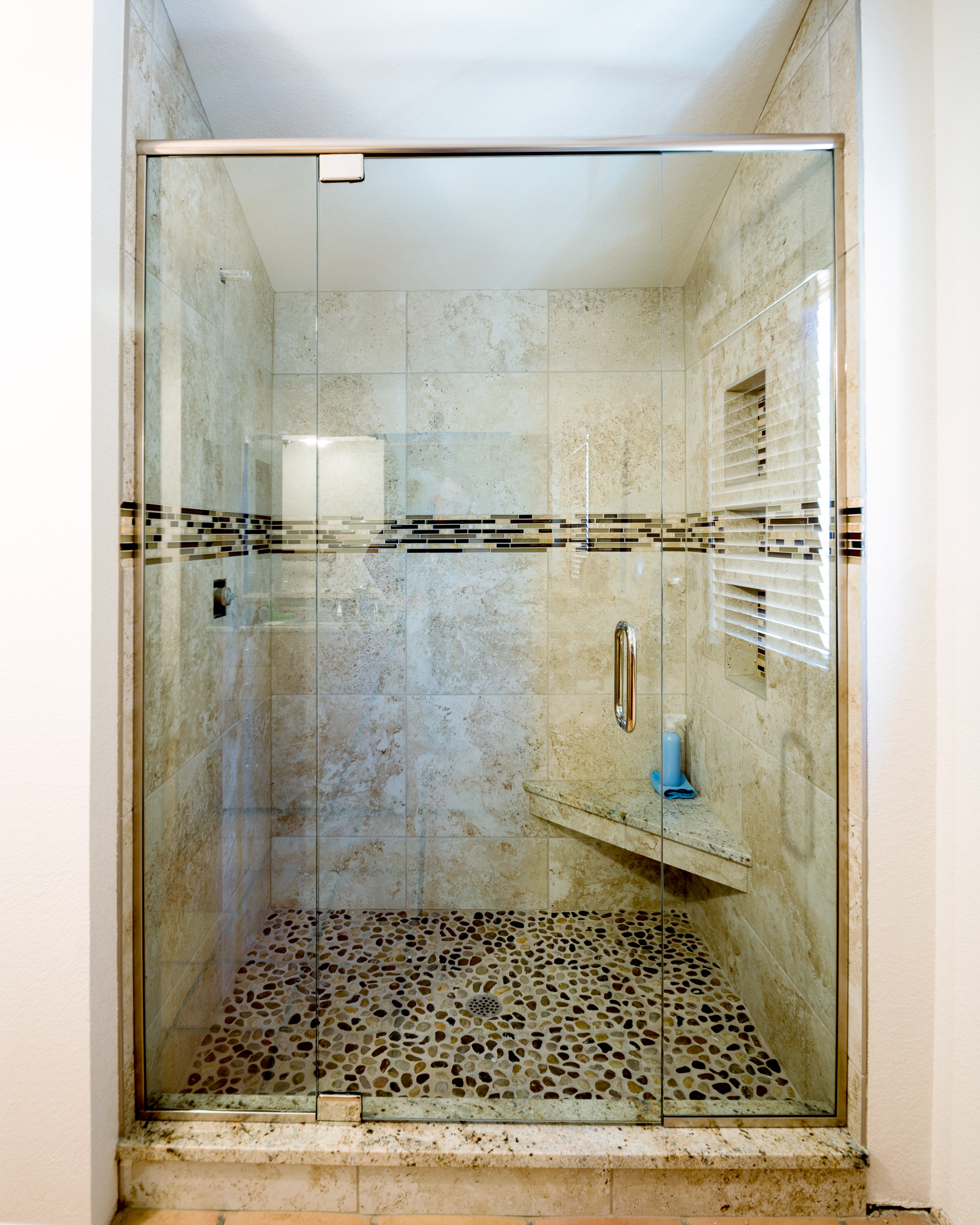 Frameless shower enclosure