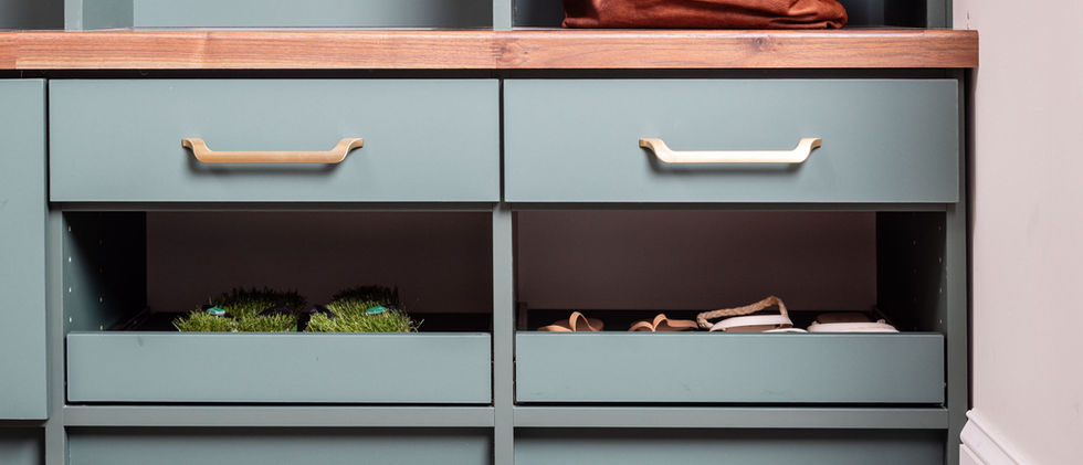 green mudroom with drawers and shoe racks