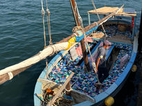 A dhow made entirely from recycled plastic sets sail on the shores of Lamu, Kenya. Built by the FlipFlopi Project, entirely from waste collected within the community, the vessel is more than just a boat; it is a declaration that change is possible.