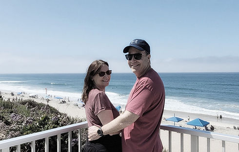 Empty nesters enjoying wine walking near the beach