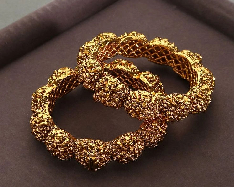 Close-up view of ornate bangles and earrings on a wooden table