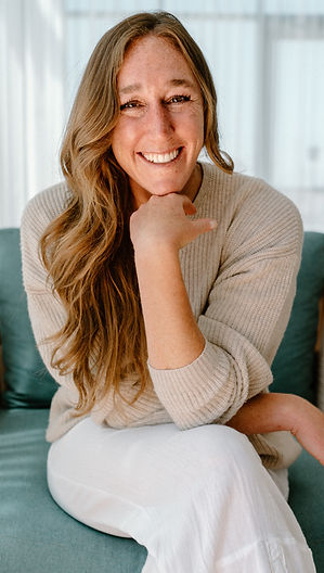 Jennifer Kelleher headshot smiling at camera with hand under chin