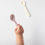 Thumbnail: beige silicone spoon and baby's hand holding pink silicone spoon