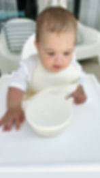 Thumbnail: baby in a high chair with beige baby bowl with lid