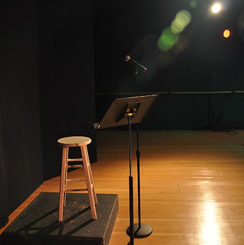 Art Defined Backstage with a stool and microphone