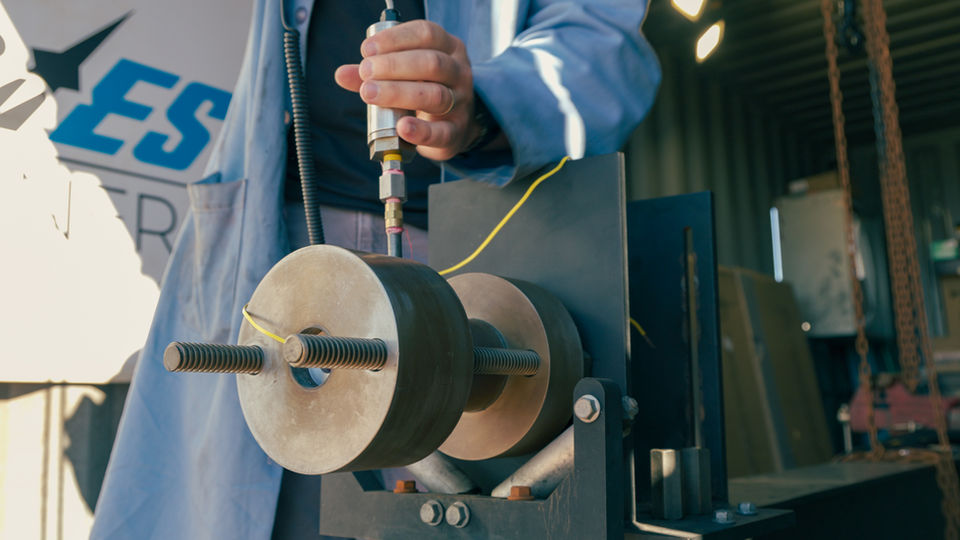 Worker adjusting solid rocket motor for testing