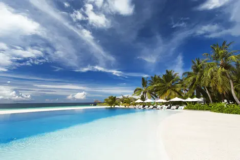Infinity pool at Velassaru Maldives, perfectly positioned with views extending over the turquoise lagoon.