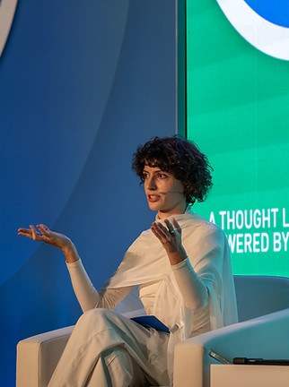 Woman speaker addressing Global Currency Forum 2024 in Oman – currency policy and innovation in focus