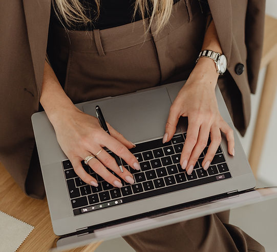 kaboompics_young-entrepreneur-dressed-in-brown-suit-holds-laptop-27938.jpg
