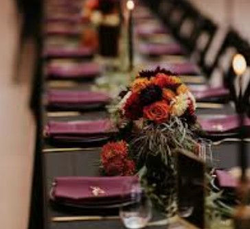 Thumbnail: black table with berry wine sangria napkins and dark gothic candles and flroals
