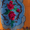 Miniaturbild: Cross stitched wall hanging tapestry  flowers on orange background 