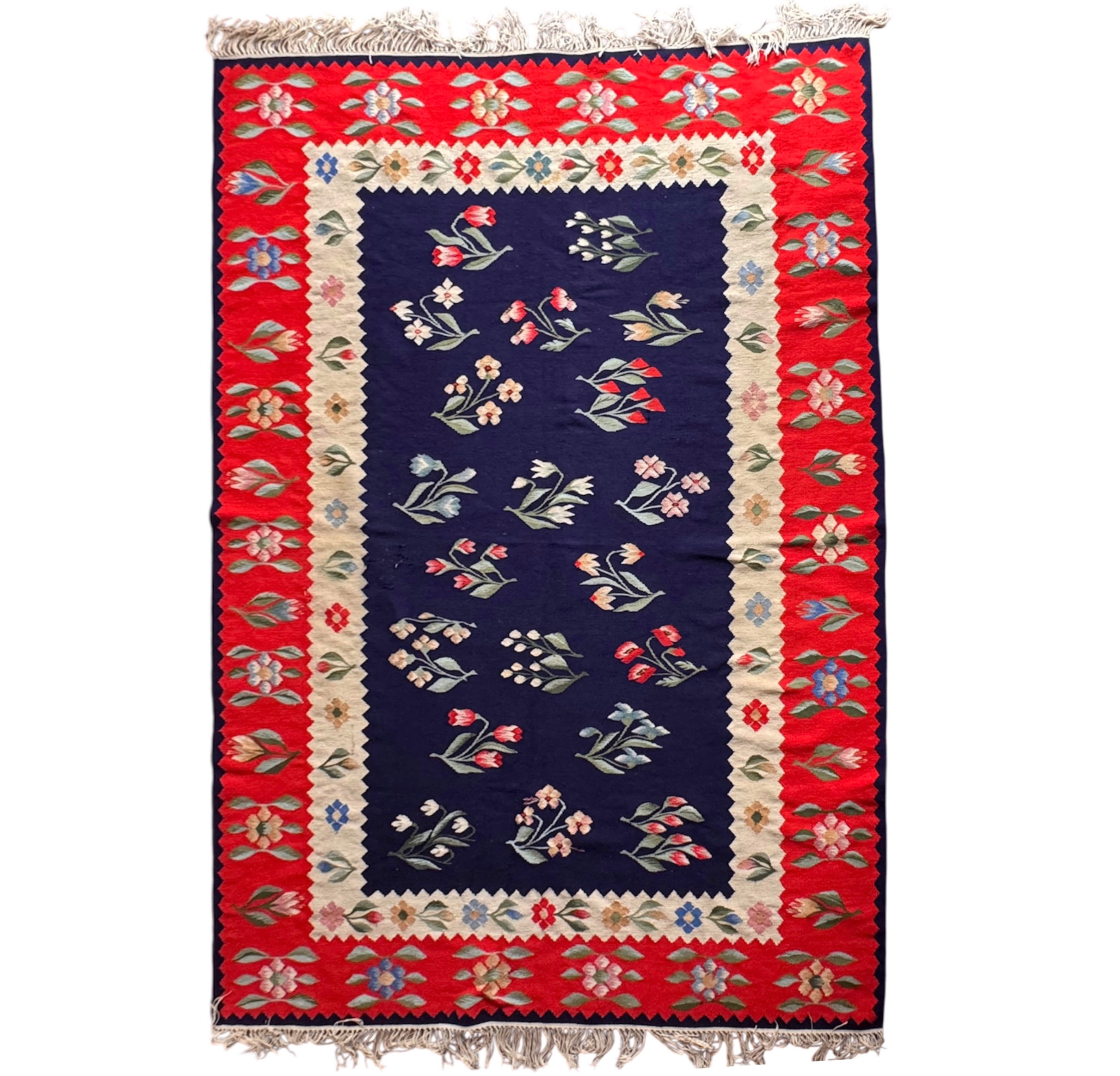 Beautiful floral Oltenia carpet on a blue and red background 