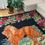 Thumbnail: Large antique rug with a majestic lion and floral decor