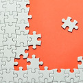 Plain white jigsaw puzzle, on orange background..jpg
