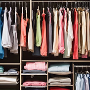 Organized closet with colorful clothes hanging and folded