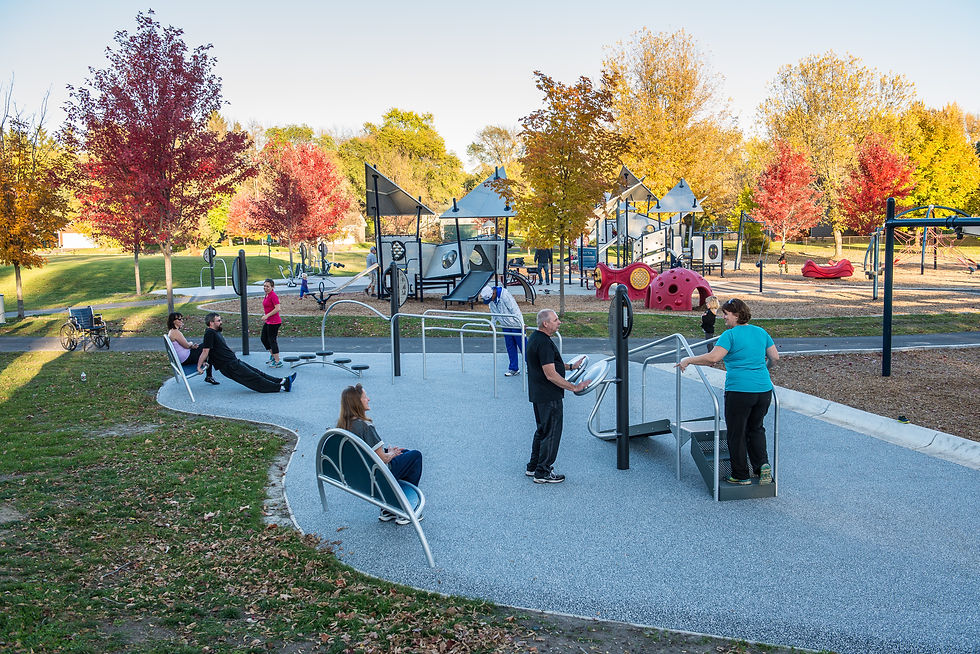 a group of people using outdoor fitness equipment from landscape structures