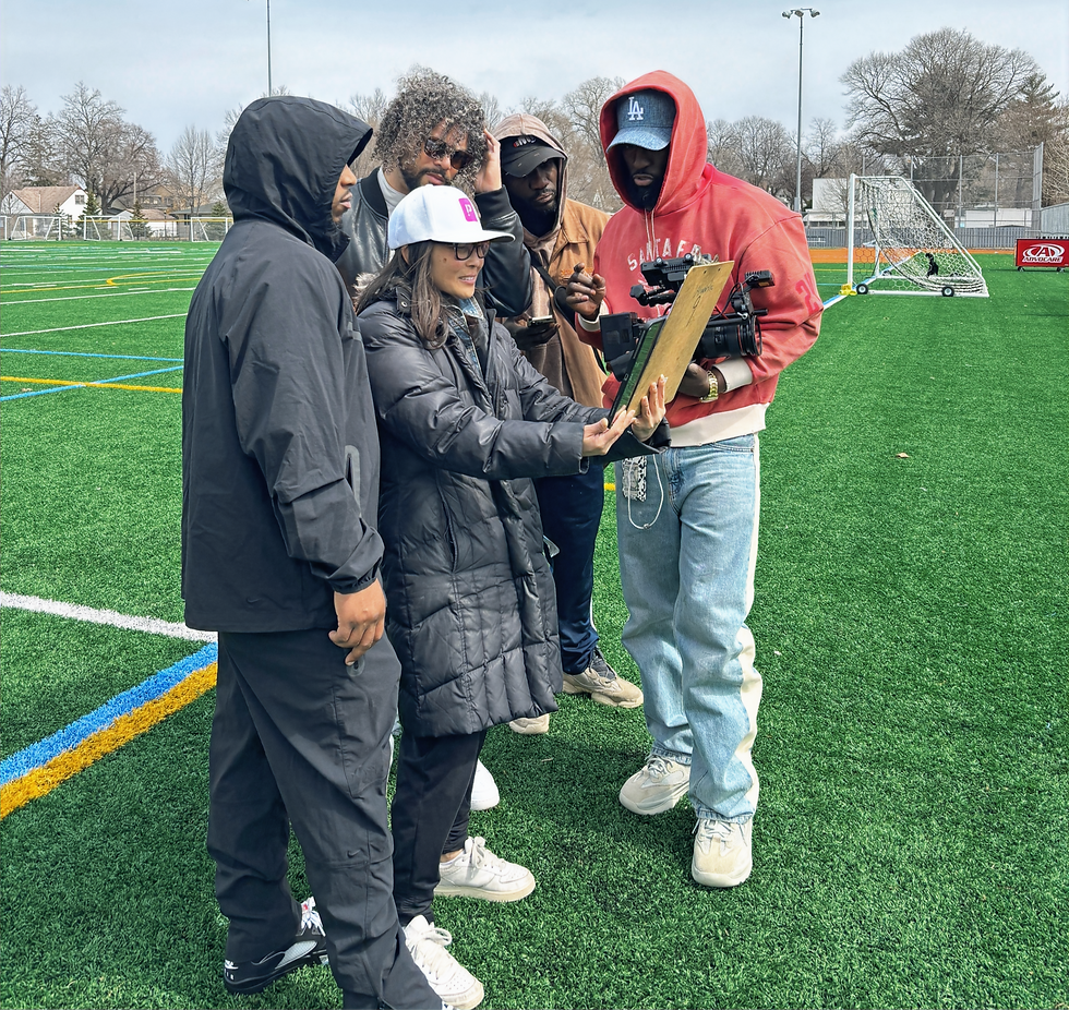 Director Ali Alowonle reviewing content with cast and crew