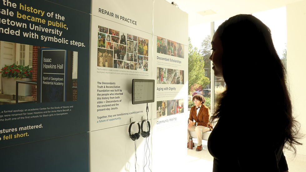 St. Thomas student observes “What We Inherit: Truth, Repair, and a Promise to the Future” exhibit.