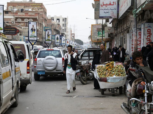A young man walking down a street in Sanaa, Yemen.
