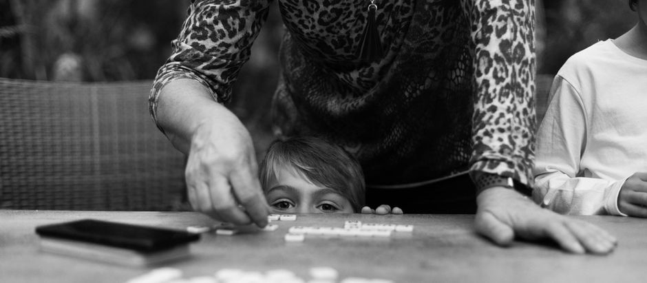 boy plays Bananagrams with his grandmother