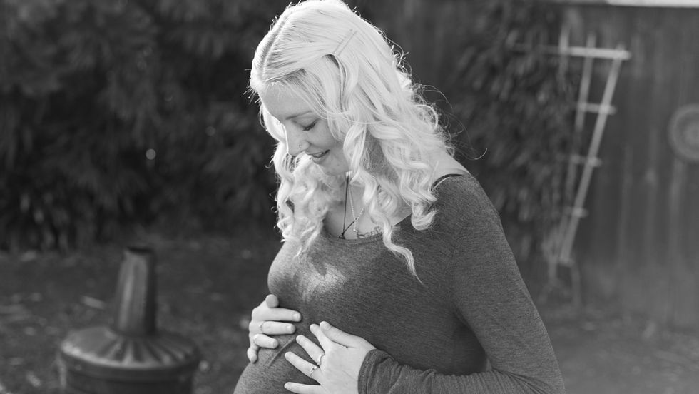 Real Family Photography mum looking at her pregnant belly