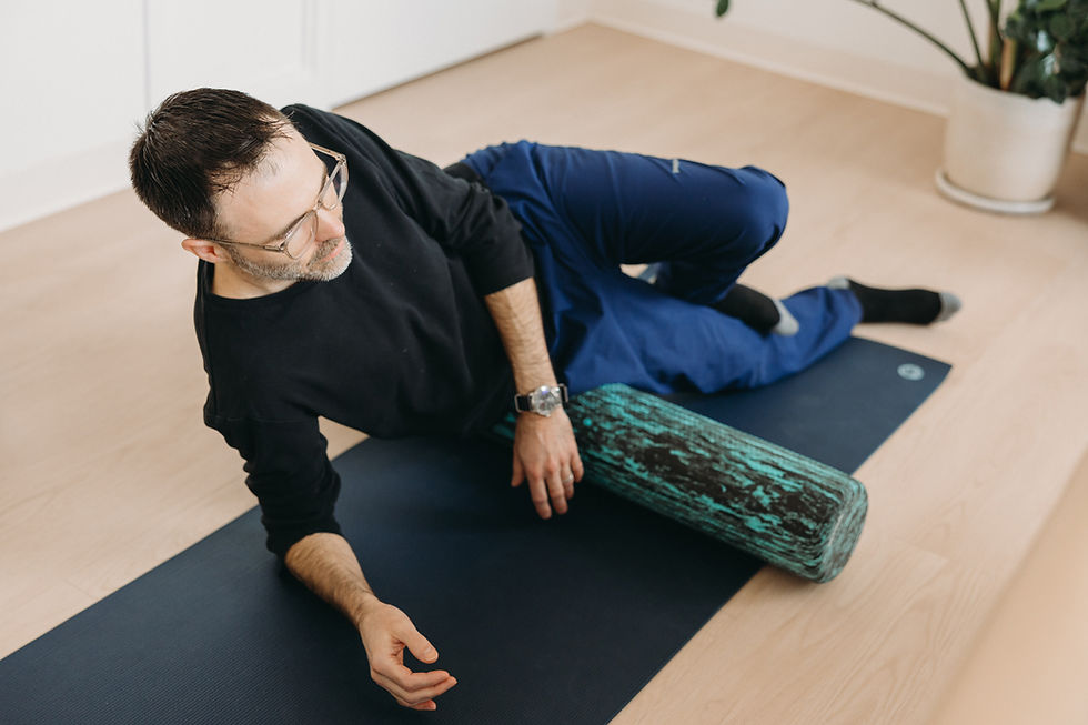 Man rolling hips on foam roller