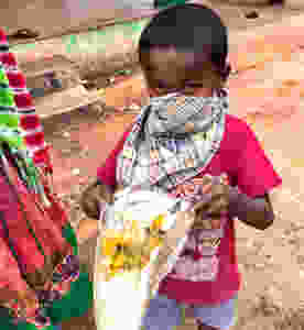 Child with mask and food