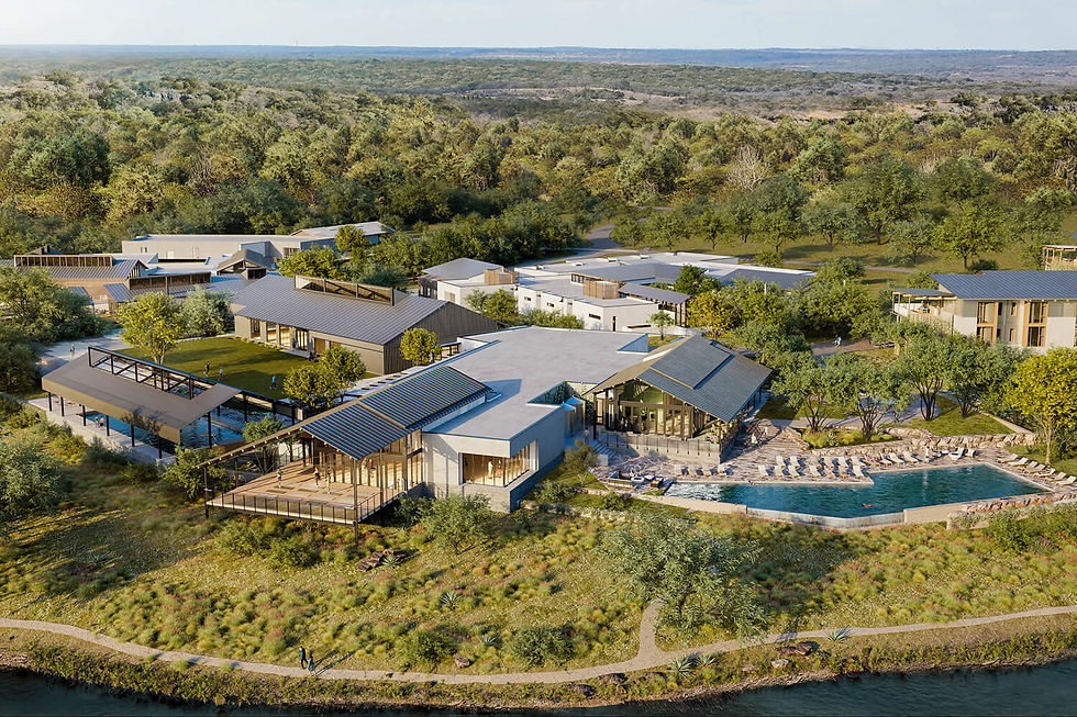 Aerial view of a modern riverside resort with blue-roofed buildings, pool, and scattered people amid lush forest.