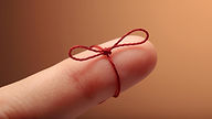finger with a string tied around it in a bow.jpg