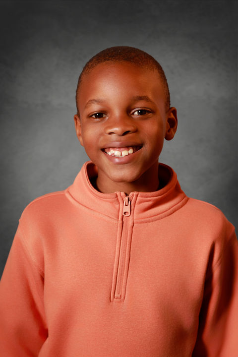 a child wearing a pink jacket
