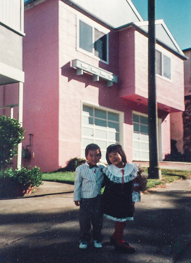 Throwback! Christina & her younger brother Edmund on Bellevue Ave, in front of their "ticky tacky box" home that they grew up in.Â