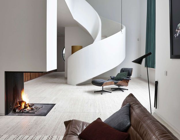 Floor-to-ceiling, open fireplace with a high firebox that presents the wood fire without a glass panel.