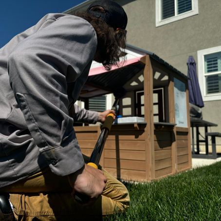 Pest control technician spraying an outdoor play area for common pests