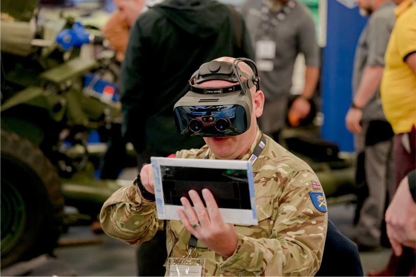 Military man plays serious game with a VR headset at DSET 2023