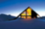Whare Kea Alpine Chalet in New Zealand's South Island stands in the snow at dusk