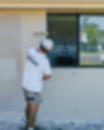 McAskill Coatings painter roller-applying exterior wall coating on a Sydney home