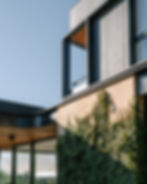 Painted render, timber cladding and sandstone detail on a modern home facade, McAskill Coatings