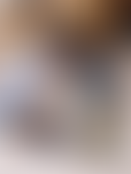 Woman pouring clothes out on a bed