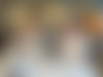 two attractive ladies smiling sat at a table in an aylesbury nursing home celebrating and drinking champagne.