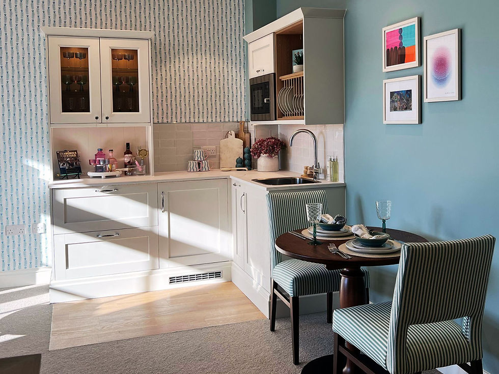 a pretty retirement apartment kitchenette with a dining area for two