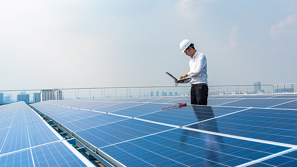 Electrical engineer using laptop to monitor the operation of the solar panels on rooftop.