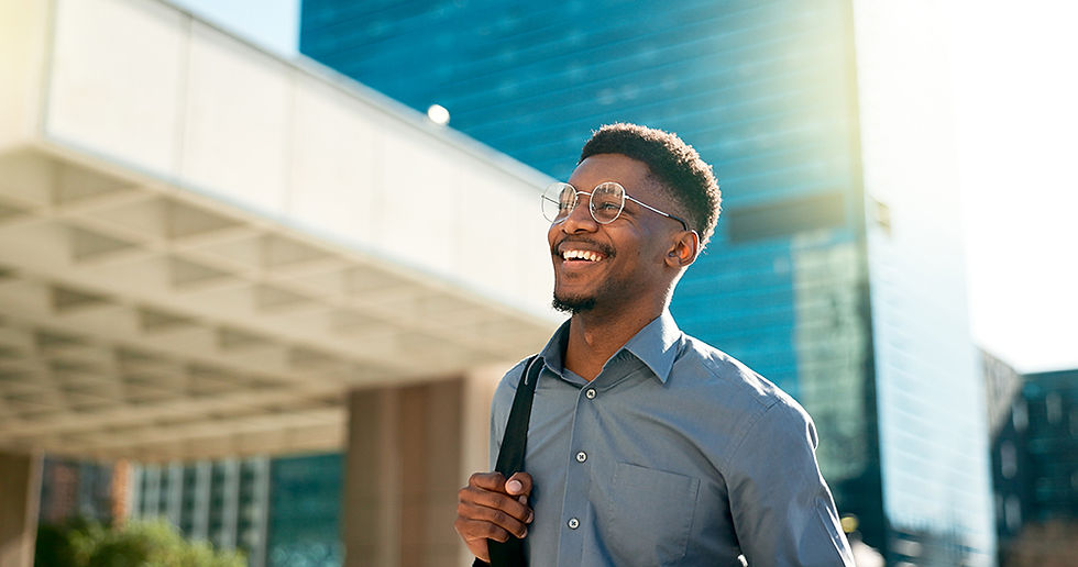 African businessman walking infront of sky scrapers