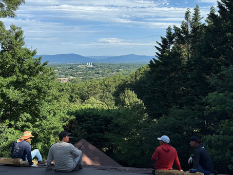 Roofers on Roof in Roanoke with overlook of Roanoke Valley