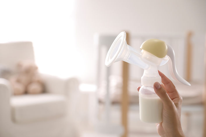 Closeup view of woman holding manual breast pump indoors, space for text Baby health.jpg