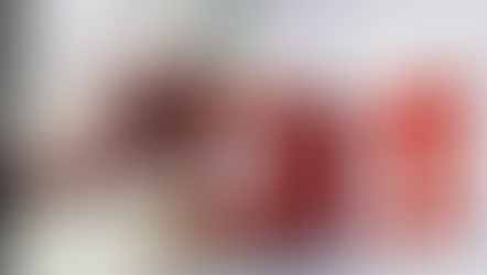 Hand pressing a red fire alarm box on a white wall, surrounded by safety notices and warning symbols. Calm setting with clear signage.